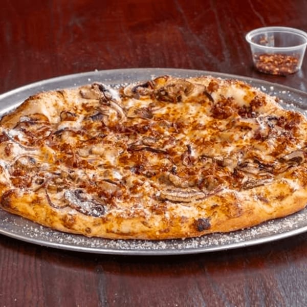 A Detroit Pizza with caramelized onions and mushrooms, dusted with parmesan, on a metal tray.